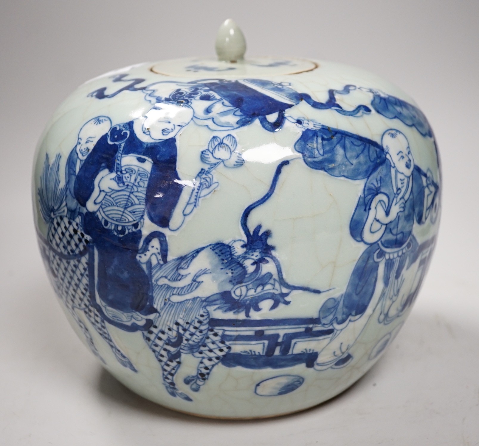A Chinese underglaze blue and slip decorated celadon crackle glazed vase and associated cover, late Qing dynasty, 21cms high